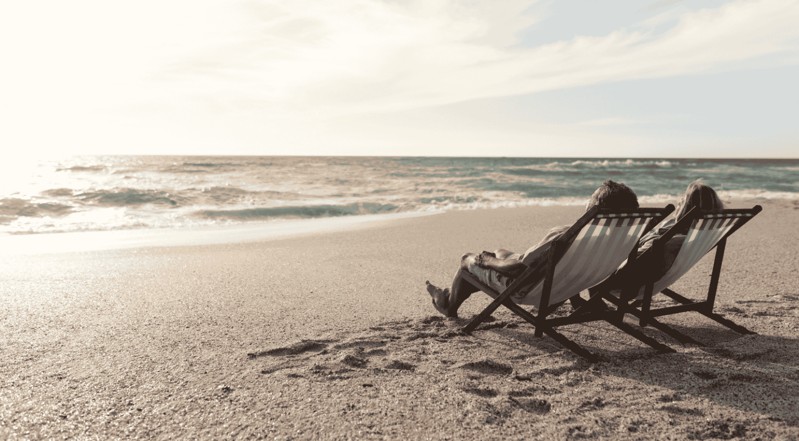 couple relaxing on beach chairs on a sandy beach